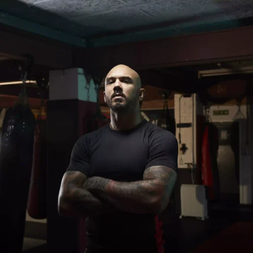A tattooed individual, showcasing fitness and strength, symbolizes the role of a bouncer service.